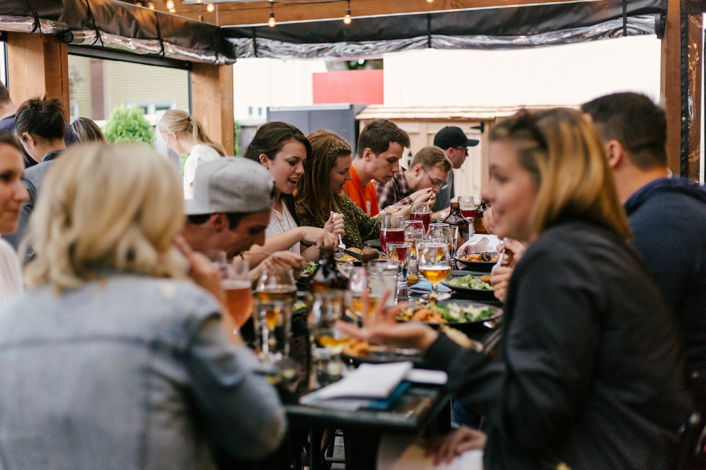 People sharing a meal and conversation around a long table